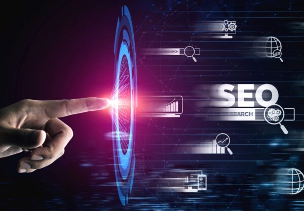 A hand is pointing at a seo icon.